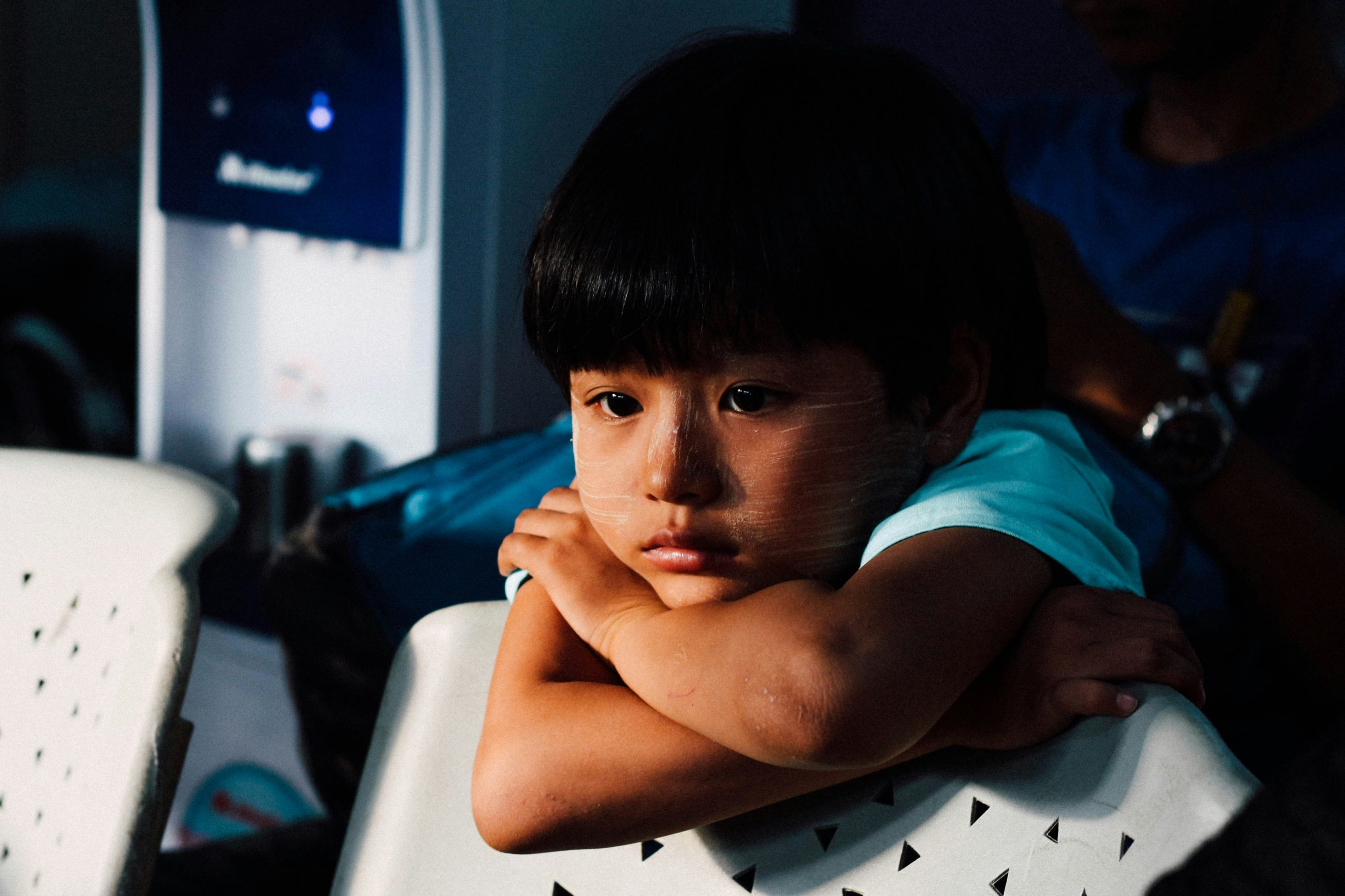 boy with arms folded looking upset