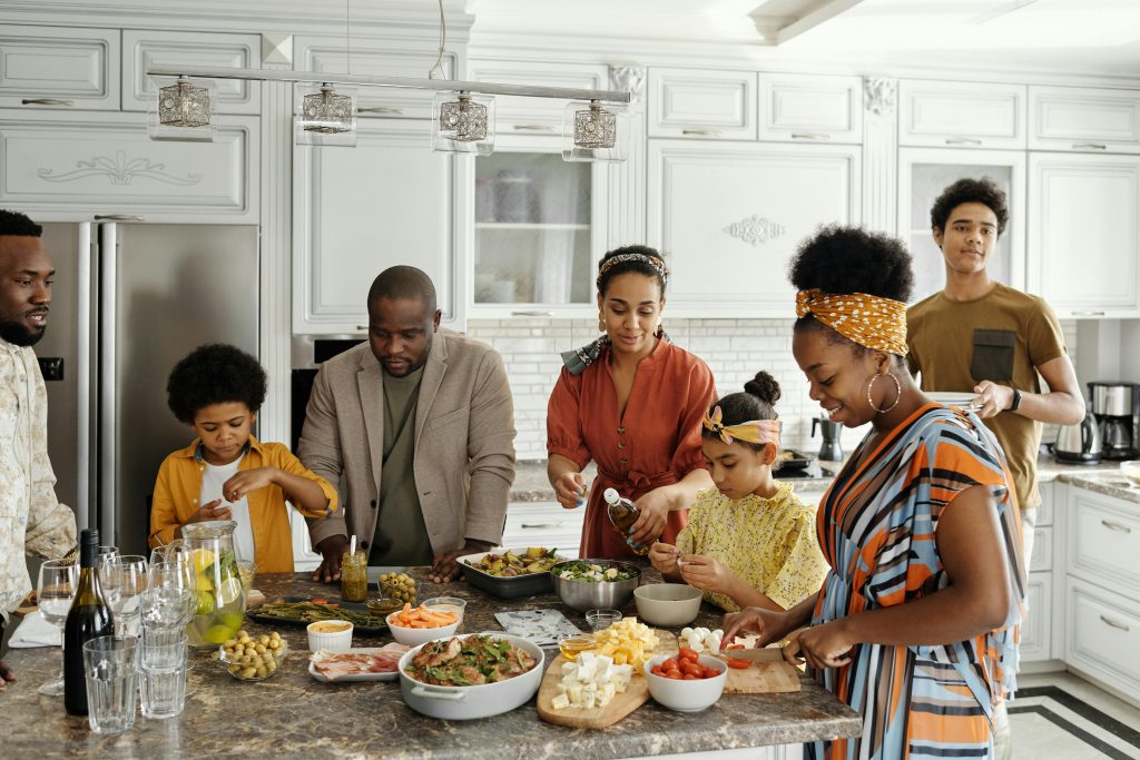 Family gathered around food in the kitchen