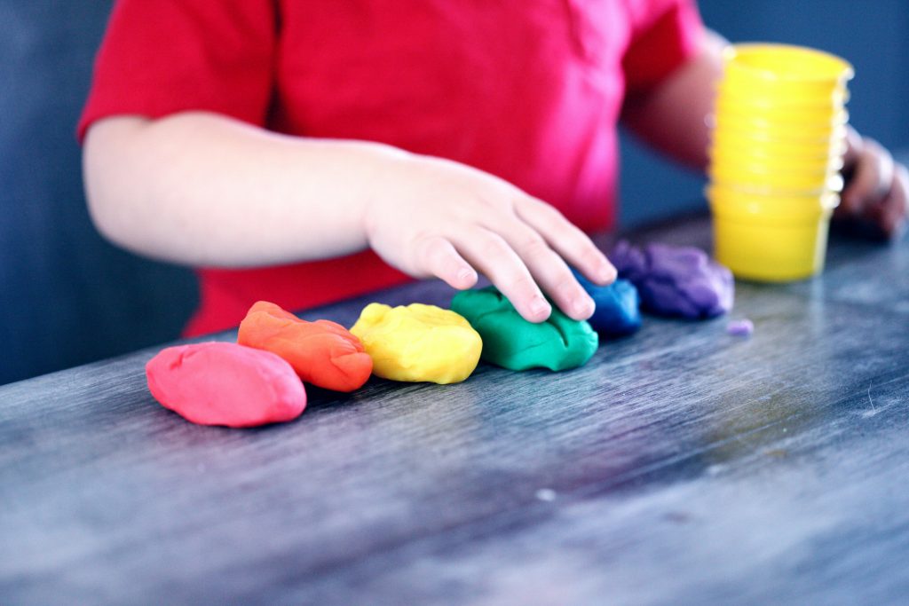 child playing with coloured dough