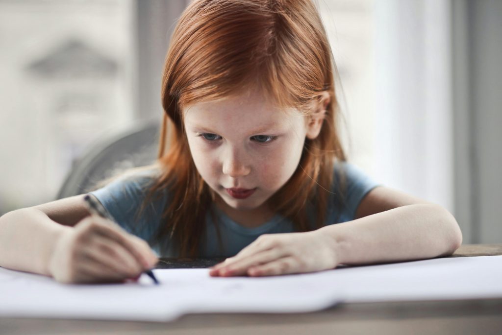 child writing in a school book